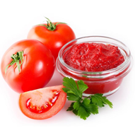 A bowl of red sauce next to tomatoes and parsley&#xD;&#xA;&#xD;&#xA;Description automatically generated